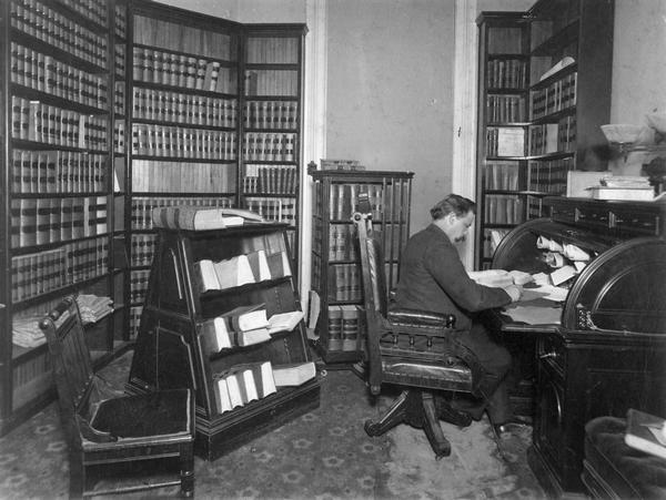 Office of Roujet Delisle Marshall, who served as Wisconsin Supreme Court Justice 1895-1918. The judge's office was located in one of the octagon tower rooms that were part of the original Wisconsin State Capitol built during the 1860s. The two chairs, which are of the Eastlake style, were probably not part of the original furnishing of the room.