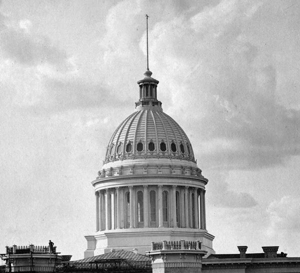 The dome of the third Wisconsin State Capitol, which was constructed entirely of iron and glass, as it appeared in 1878. The dome was painted white which some contemporary observers felt did not blend well with the buff colored Prairie du Chien sandstone of the rest of the building.