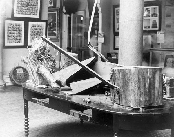 Artifacts from the New Richmond tornado on display in the Historical Society's museum in the Wisconsin State Capitol. The display of such curiosities, now out of scope in a historical museum, was not unusual at the time. Although it is in poor condition, the table may have been part of the original furnishings when the Society moved to the Capitol in 1866.