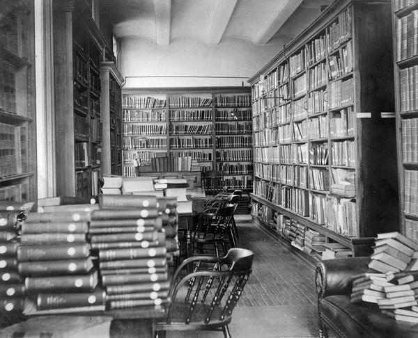 The Genealogical Alcove in the Historical Society's quarters in the third Wisconsin State Capitol. Although the Society had only moved into these rooms in 1883, it is clear that conditions were already very crowded by the time this picture was taken. In 1900 the Society was able to move to its own, more spacious building on State Street.