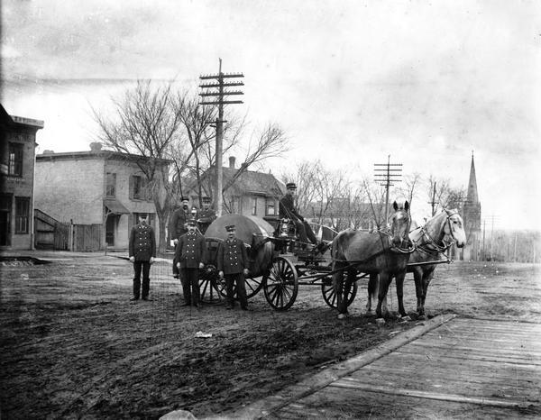 Madison fire fighters with a hose wagon near the intersection of Webster Street and East Washington Avenue.