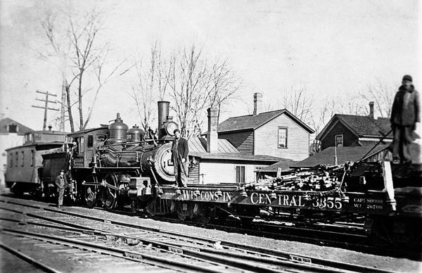 Wisconsin Central Railway locomotive #2035 and a work train on a track clean-up assignment. Locomotive #102 was built by the Baldwin Locomotive Works in 1887.