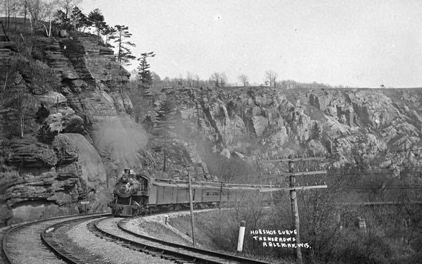 View of a passenger train coming down the tracks at the Horseshoe Curve. Rock Springs was called Ableman until 1947.