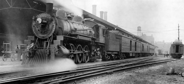 Minneapolis, St. Paul, and Sault Ste. Marie Railway's locomotive #704 photographed at Rugby Junction, where the train made a connection with the main line train. The Soo Line abandoned passenger service at Rugby Junction on July 30, 1938. This is the last train out of the Union Station that made the connection to Rugby Junction. Although they do not appear here, the engineer was Tay Morgan, the fireman Carl Turznich, and the conductor was Jim McCarthy. Presented by Roy L. Martin.