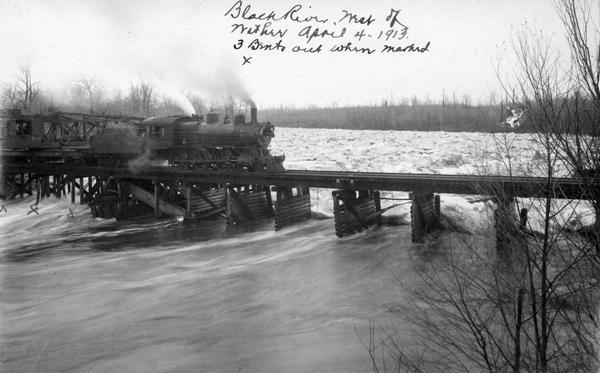 Elevated view of the Soo Line train crossing a bridge over the Black River near Withee. The three x's indicate places where the bridge had been damaged by an ice jam.