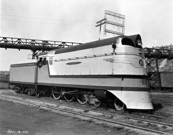 Chicago, Milwaukee & St. Paul Railway engine #10, the "Hiawatha," built by the company shop in Milwaukee. There are houses in the far background along a ridge.