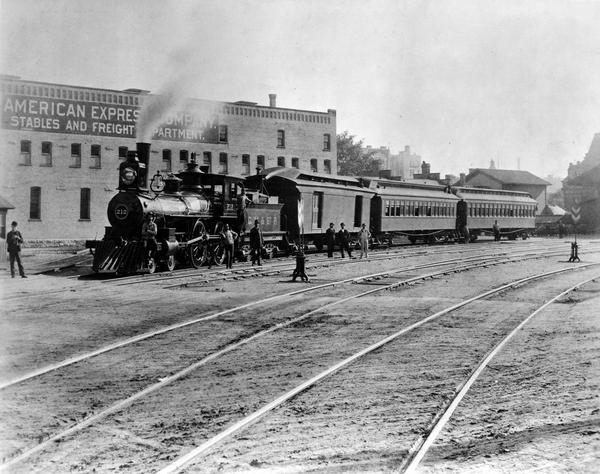 View across railroad tracks of the Chicago, Milwaukee & St. Paul Railway engine #212, also known as the Waukesha Scoot, at Milwaukee's Union Depot.