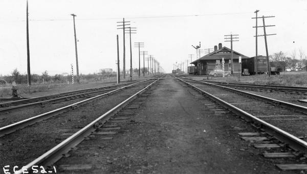 View down railroad tracks towards the Central Avenue depot and the railroad crossing.