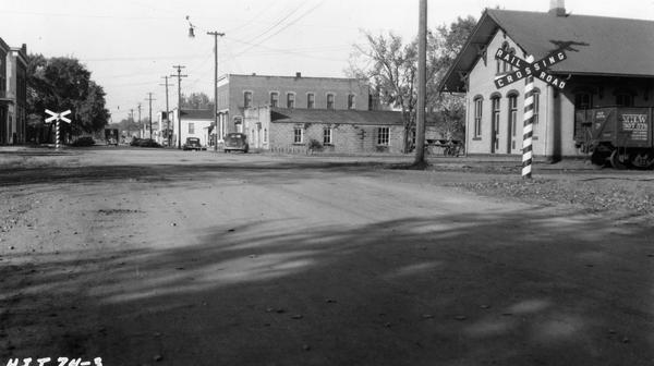 Railroad crossing, also showing the main street and the train depot.