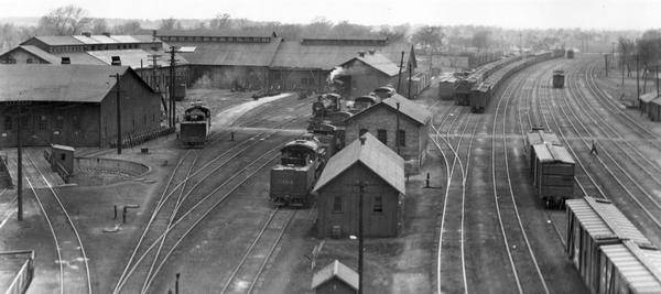 Elevated view of the Chicago, Milwaukee & St. Paul Railway yard and roundhouse (left) on South Oakland Avenue.