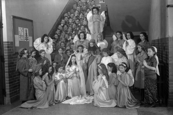 The cast of the Nativity Christmas pageant of Blessed Sacrament Church, posed on a stairway in their costumes.
