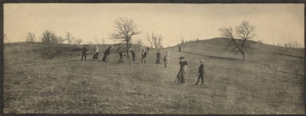 People playing golf on Thomas Ridge at Hillside Home School, an early progressive school operated by Ellen and Jane Lloyd Jones, aunts of Frank Lloyd Wright.