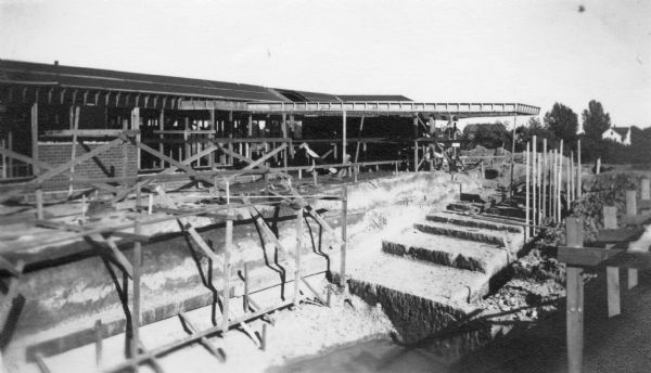 Construction of the Herbert F. Johnson Residence, "Wingspread." In the foreground are the walls and steps of the swimming pool and the rear elevation of the residence. The building, designed by Frank Lloyd Wright, was completed in 1937.
