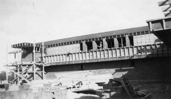 Workman on the construction of the second floor of Herbert F. Johnson's Residence, "Wingspread," designed by Frank Lloyd Wright. The residence was completed in 1937.