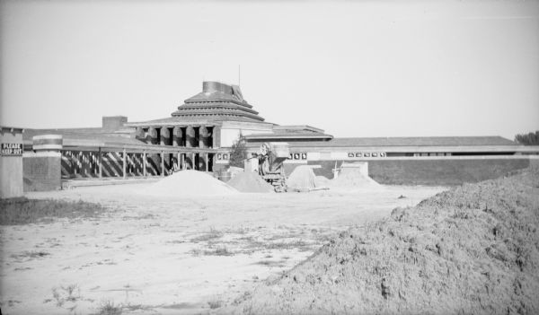 Piles of sand and dirt in front of the Herbert F. Johnson Residence, "Wingspread," during construction. The residence was designed by Frank Lloyd Wright and completed in 1937.