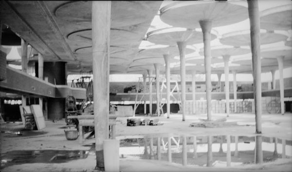 Interior of the two-story work space in the Johnson Wax Building during construction showing the tapered columns. The building was designed by Frank Lloyd Wright.
