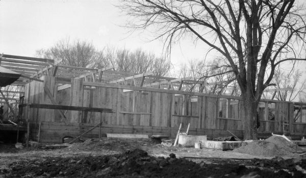 Construction of the Hillside drafting studio at the Taliesin Fellowship Complex. The roof trusses are in place and the walls and window openings for the apprentice rooms are complete. The studio was designed by Frank Lloyd Wright and was a drafting studio for the Taliesin Fellowship. Taliesin is located in the vicinity of Spring Green.