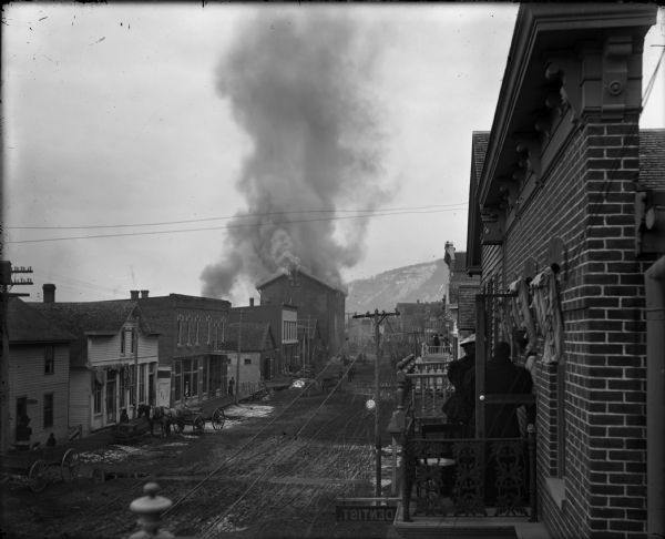 Street view showing Alma Milling Co. building on fire. Photograph was taken from Gerhard Gesell's studio balcony.