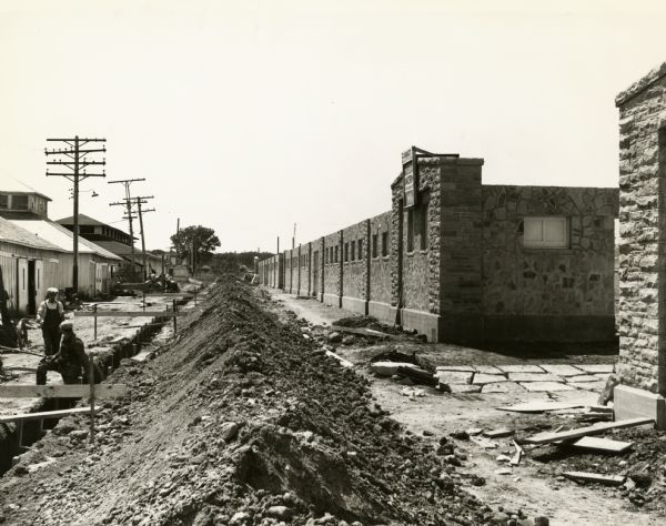 A WPA program on the State Fair Grounds. The workers have dug a long trench, and the project probably concerns improved sanitary facilities for the fair, as well as the construction of the North Barns.