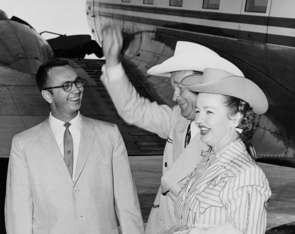 Motion picture and television "cowboy" stars Roy Rogers and Dale Evans arrive in Milwaukee for their appearance at the Wisconsin State Fair.  Although undated, the photograph probably documents their 1958 appearance.