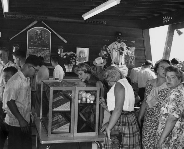 Fairgoers viewing a special exhibit of Milwaukee Braves memorabilia.  This was the first season during which the Braves played in Milwaukee.