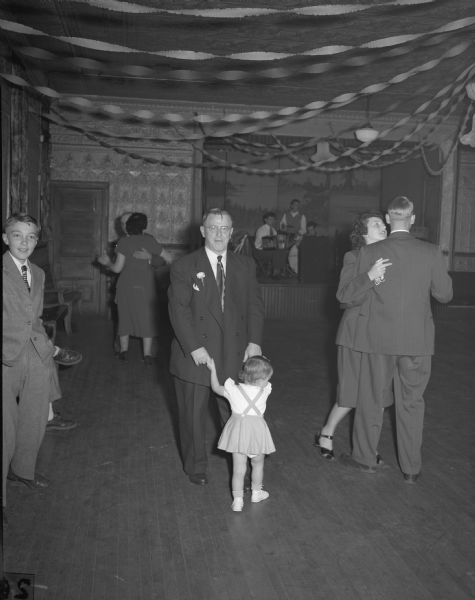 Unidentified couple dancing at the wedding of Kenneth Hoerres: a little girl and an adult man, perhaps her grandfather. In background are several other couples and the band.