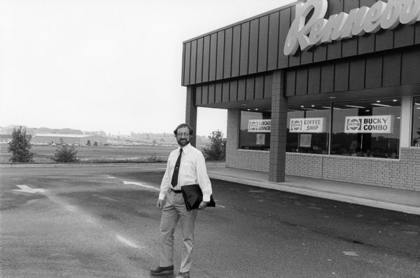 Steven O. Kimbrough outside the Rennebohm Drug Store No. 20, 6725 Odana Road, with the Beltline in the distance. In 1970 Kimbrough and photographer Chuck Patch were engaged in a project to eat breakfast and photographically document all Rennebohm restaurants in the Madison area.