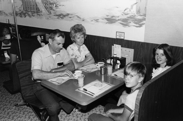 A family of four waits for their breakfast to be served at the Rennebohm Drug Store No. 4 restaurant in the Hilldale Shopping Center, 702 N. Midvale Blvd. As a member of the University of Wisconsin Board of Regents, former governor Oscar Rennebohm, also the founder of the Rennebohm chain, was actively involved in the development of the former University property as a shopping mall.