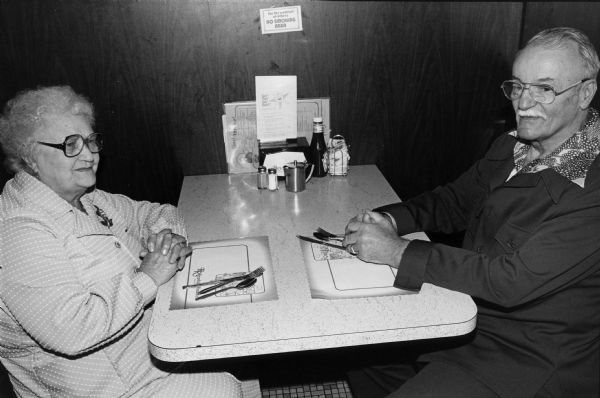 A couple waits for a waitress to take their order at Rennebohm Drug Store No. 19 restaurant, 204 Cottage Grove Road, the present site of the Madison Public Library's Pinney Branch.