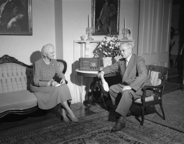 Governor and Mrs. Oscar Rennebohm in the Governor's Residence, 130 E. Gilman Street, listening to the election returns on the radio.  Some of the mansion's decor is visible in the background. Rennebohm, the wealthy founder of Rennebohm Drug Stores, Inc., was a novice in politics when he was elected lieutenant governor in 1944.  In 1947 he became governor when Governor Walter Goodland died in office.  In 1948 Rennebohm was re-elected governor in his own right.