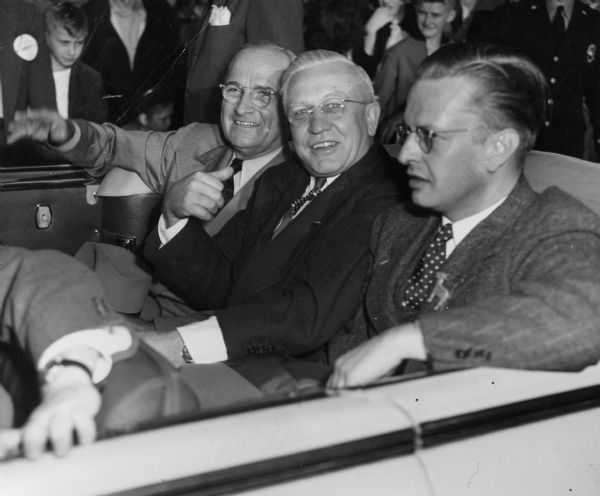President Harry Truman, Governor Oscar Rennebohm, and Senator Carl Thompson of Stoughton riding in the back of an open car during a Presidential visit to Madison in 1948.  Although active in charitable work and in professional organizations, Rennebohm, the wealthy founder of Rennebohm Drug Stores, Inc., had little experience in politics when he was elected lieutenant governor in 1944.  Rennbohm became governor when Governor Goodland died in office in 1947.