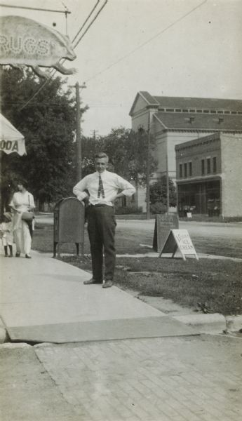 Oscar Rennebohm standing in front of the Badger Pharmacy on University Avenue.  Behind him, across the street, the University of Wisconsin Physical Plant can be seen.  Rennebohm purchased the bankrupt pharmacy in 1912 when he was still in his early 20s. He would eventually build it into a chain, Rennebohm Drug Stores, Inc.,  and Rennebohm, by then a wealthy man, went on to become governor of Wisconsin in 1947.