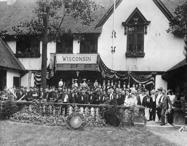 The Joseph Clauder Marching Band from Milwaukee pose in front of the Wisconsin Building at the St. Louis World's Fair. Clauder's band was one of the most prominent of Milwaukee's German bands during the 19th Century. In addition, he was a well-known composer and the conductor of the Davidson Theater Orchester for twenty-five years.