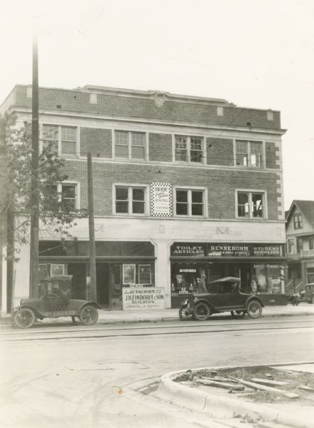 The Rennebohm Drug Store #1 at the corner of University Avenue and Randall Avenue, which replaced Rennebohm's first store located just across the street. Although still under construction, the building already housed Rennebohm's Badger Pharmacy which had moved from its former location across the street. A sign indicates that the building was constructed by J.H. Findorff, with J. Gaetli as engineer. Upstairs, realtor Stanley Hanks is preparing to rent space as offices and apartments. The store next to Rennebohm's would eventually become a Western Union office.