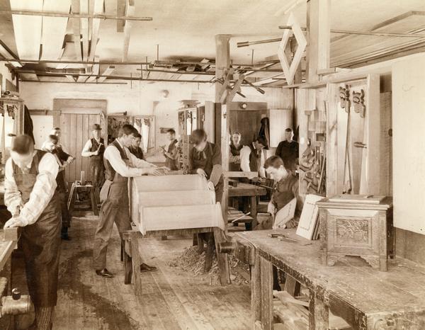 Male students at the State School for the Deaf practice woodworking in one of the school's shops.
