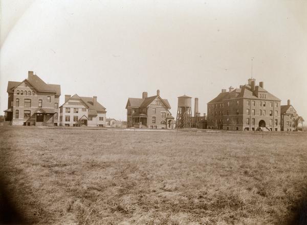 Exterior of the State Public School grounds, with numerous school buildings.