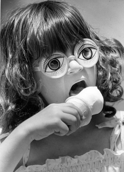 Tina Polley looked through a pair of large clown eyeglasses as she ate an ice cream cone at an Ice Cream and Pie Social at St. Francis Episcopal Church.