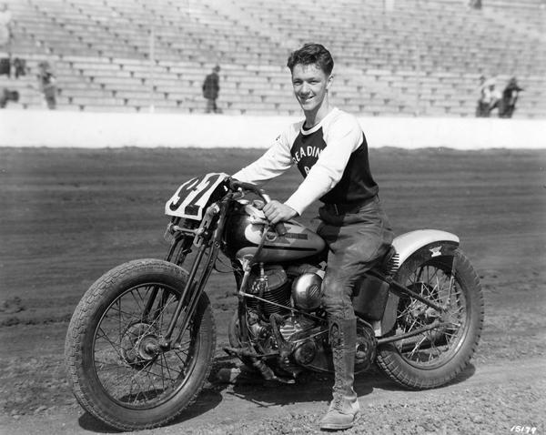 Billy Huber of Reading, PA, dubbed "America's most popular motorcycle competition rider" by the American Motorcycle Association, is shown astride his Harley Davidson cycle, prior to challenging a star studded field of over 150 racers in the 10 Mile National Dirt Track Championship race at the Wisconsin State Fair track.