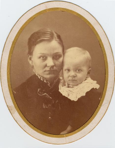Oval studio portrait of Christine Gesell, the photographer's wife, and son Arnold Gesell. Caption on reverse reads "1/2 yr - 1 yr."