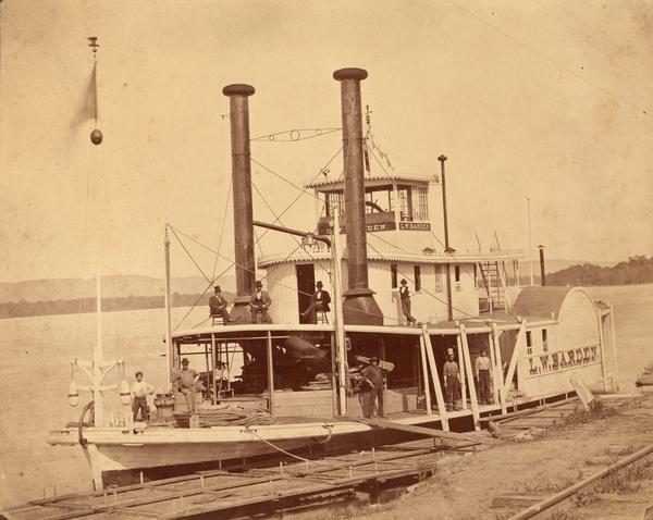 Steamer "L.W. Barden" at a landing, with ten men, possibly the boat's crew, on board.