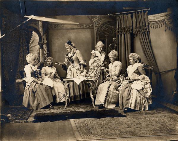 Tableaux of "Martha Washington's Tea Party" enacted by Mrs. Gesell and friends. Left to right: Mrs. Schaettle, Mrs. Kempter, (the younger) Mrs. Fritz Laue, Mrs. Gesell pours, Mrs. Eller and the elder Mrs. Kempter.