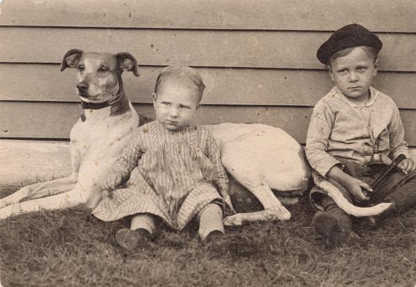 Gesell children posed with a dog. Arnold is on the right.