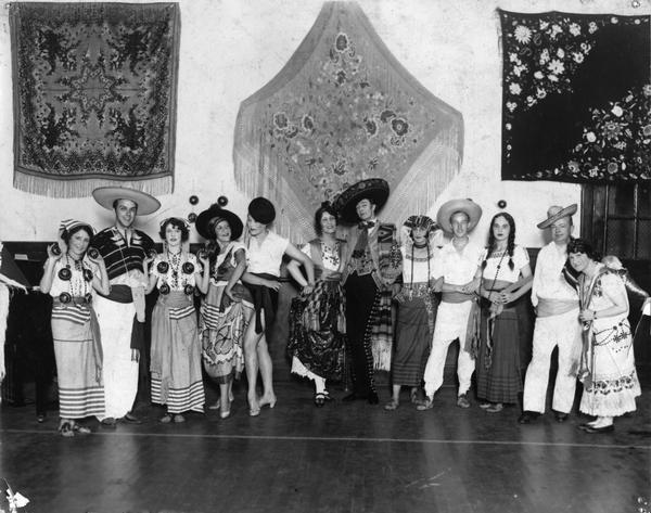 A group of 12 dancers pose in Mexican costume at the Kehl School of Dance. Leo Kehl, head of the school, appears second from the left.