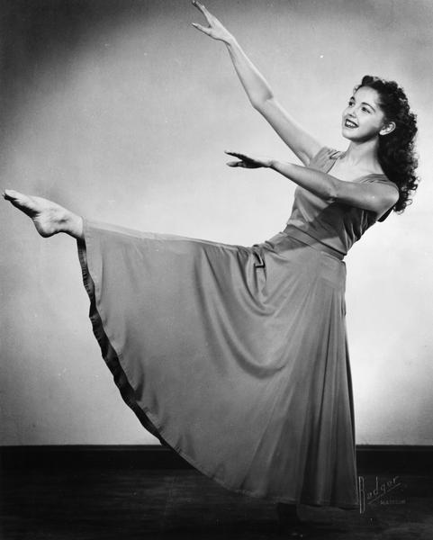 Virginia Lee Kehl Mackesey of the Kehl School of Dance, poses in a dance move with leg and arms extended.