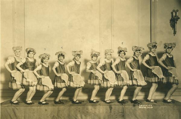 A young group of students poses with bows on their heads at the Kehl School of Dance. Third from left is Ann Jackson, fourth from left is Betty Reichardt, and eighth from left is Mary Ellen Breitenback.