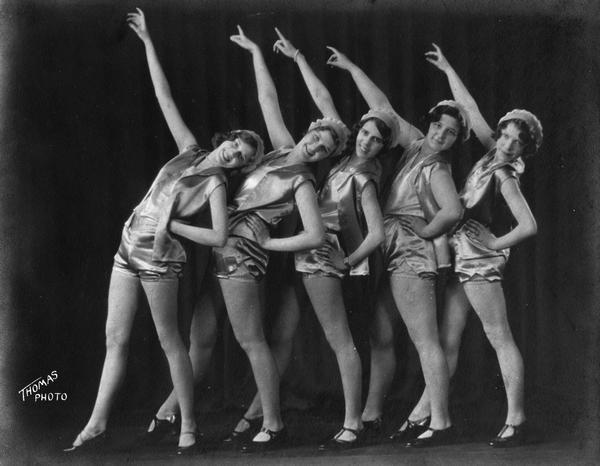 Five women pose with arms raised at the Kehl School of Dance.