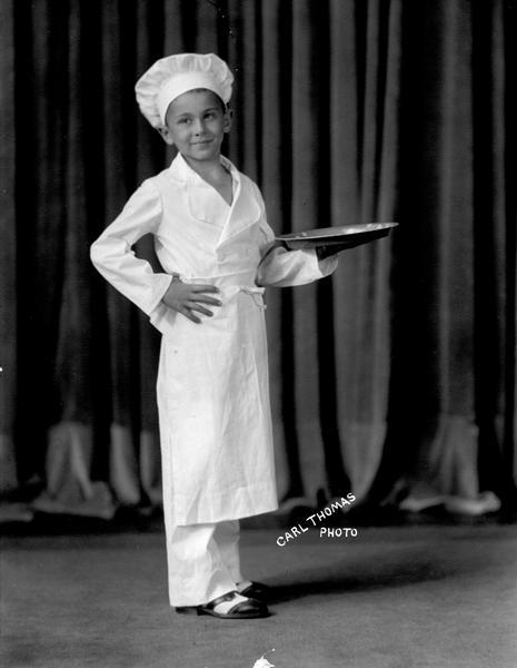 Lowell(?) Hoffmaster, a student at the Kehl School of Dance, poses in chef's costume with a serving tray.