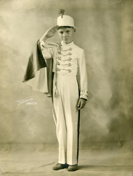 Cameron McCarthy, a student at the Kehl School, wears a drum major costume and poses in a salute.