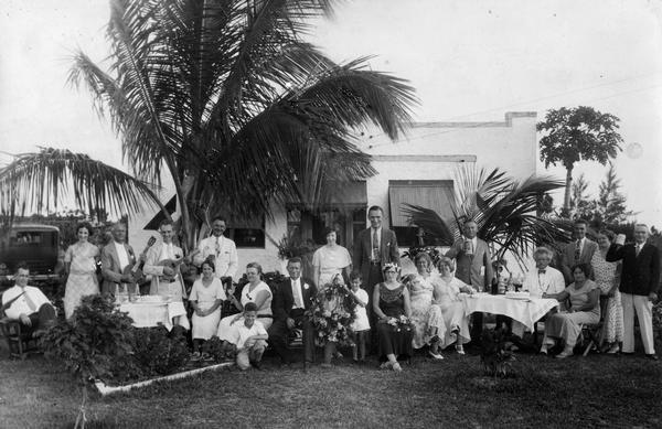 Portrait of Frederick Kehl, founder of the Kehl School of Dance in Madison, Wisconsin, with a large group, probably taken at a party at his Florida home.