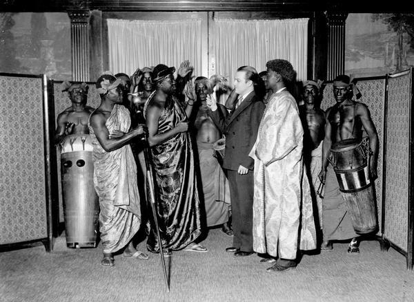 Leo Kehl, head of the Kehl School of Dance in Madison, Wisconsin, poses with a group of African men in native attire on an unknown occasion.